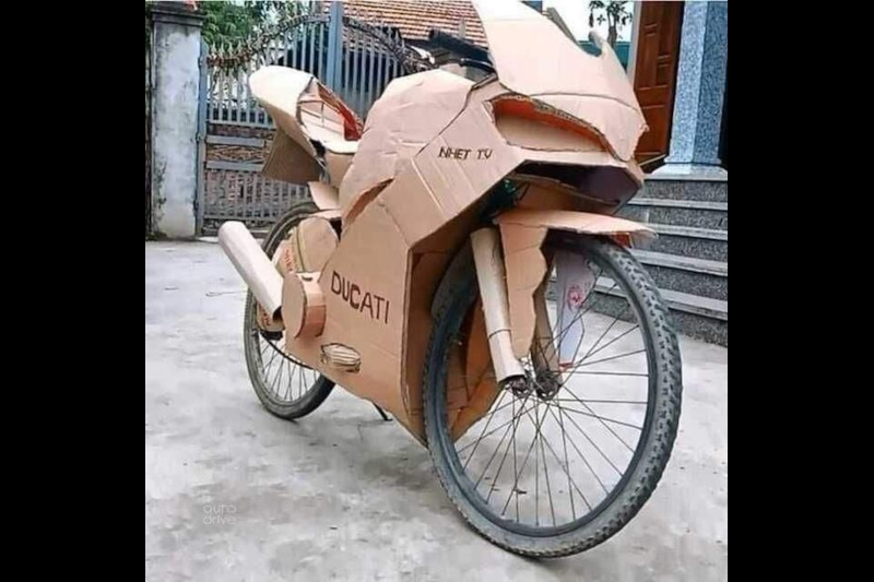 A bicycle disguised as a motorbike with cardboard